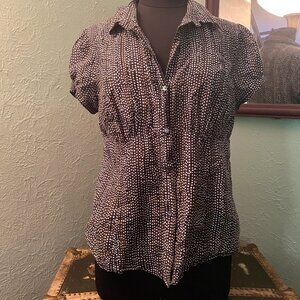Black vintage-style short-sleeved blouse with white and yellow polka dots.